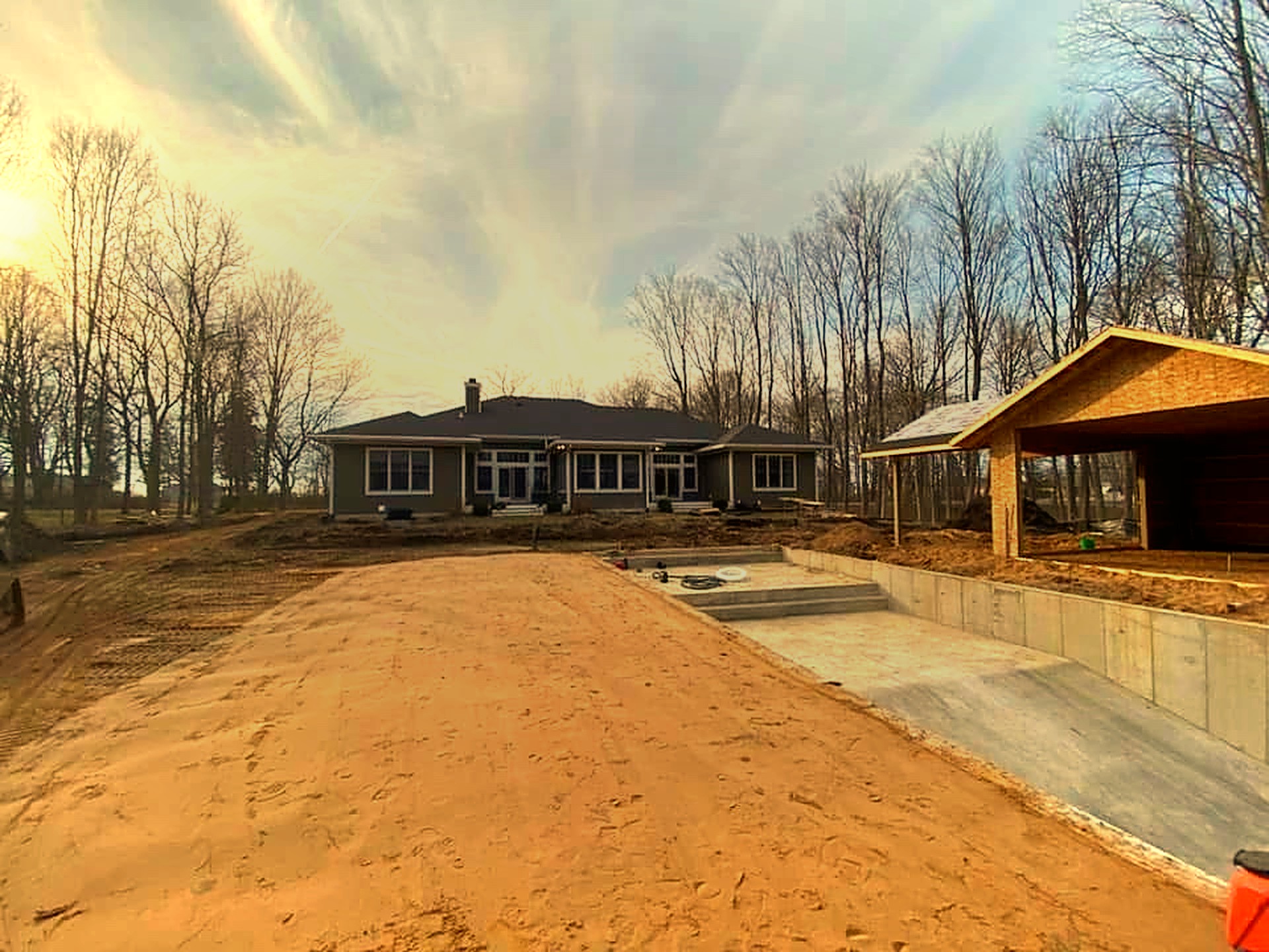 Walker Precision Excavating equipment on a Michiana job site at golden hour